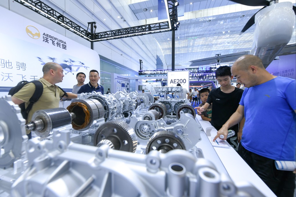 Visitors learn about a dual-motor drive system for a new energy vehicle at an exhibition on the sidelines of the 2024 World Power Battery Conference in Yibin. Photo: Xinhua