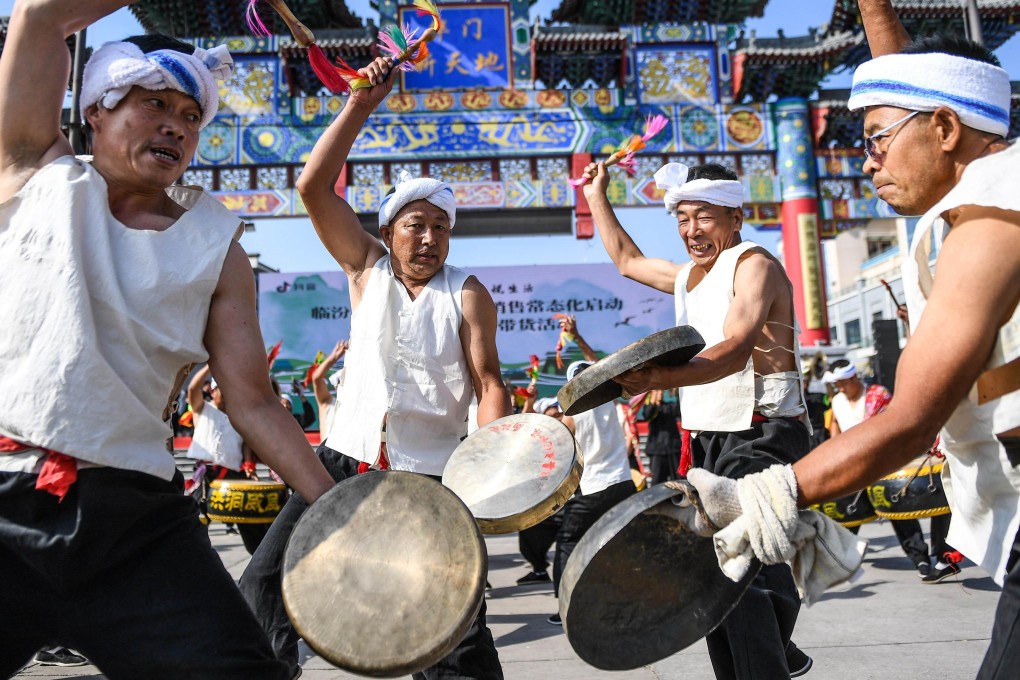Performers strike hand-held gongs during cerebrations for the Dragon Boat Festival in Linfen, China, in 2020. Of the metal instruments played in a Chinese orchestra, gongs and chime bells are the most common. Photo: Getty Images
