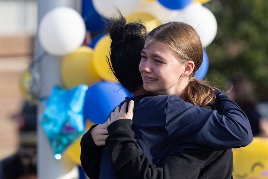 A student embraces her classmate near a makeshift memorial at Apalachee High School in Winder, Georgia, on September 5. Photo: Getty Images via AFP