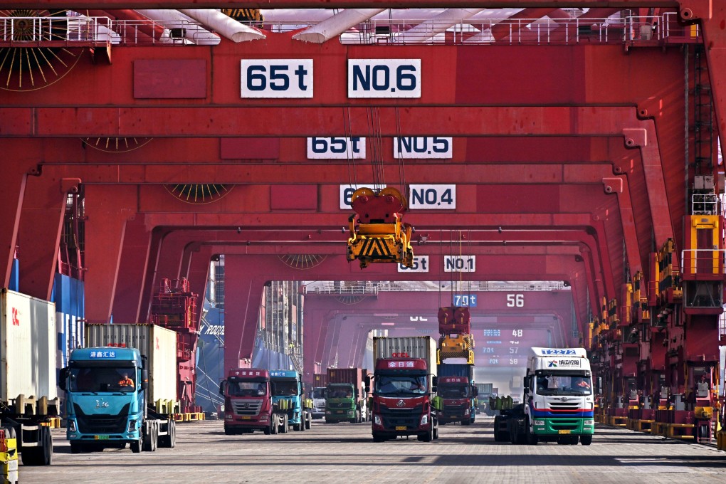 Trucks transport containers at Qingdao Port, east China’s Shandong Province, in February. Photo: Xinhua