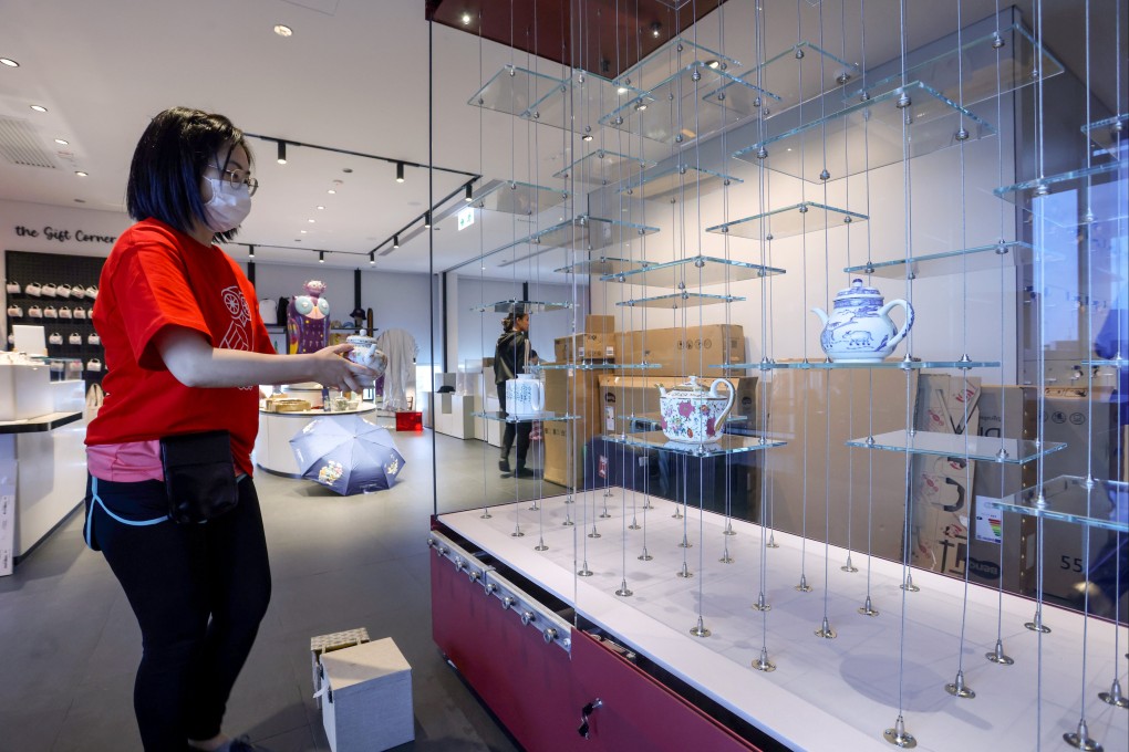 A museum staff member sets up a tea pot exhibit at the GuWei Museum in Wong Chuk Hang. Photo: Jonathan Wong