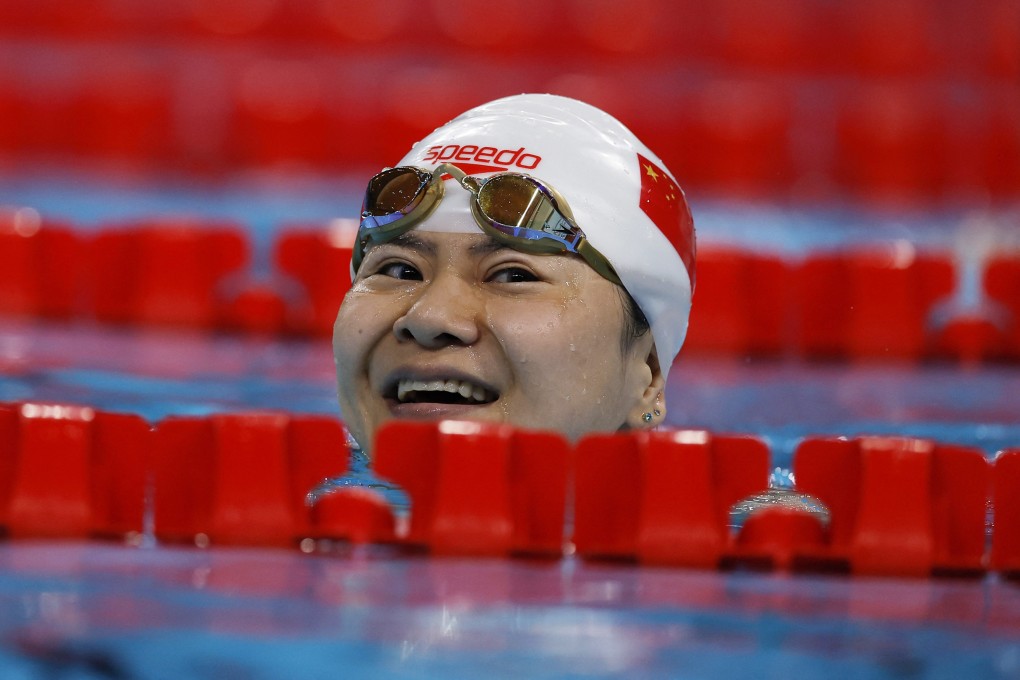 China’s Lu Dong peers over a lane separator after winning gold in the women’s 50m butterfly S5 final at the Paris Paralympics. Photo: Reuters