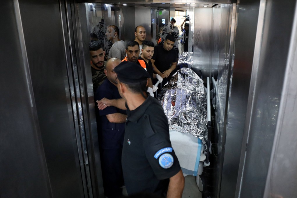 Medical staff transport the body of a US citizen at a hospital in Nablus in the occupied West Bank on Friday. Photo: AFP