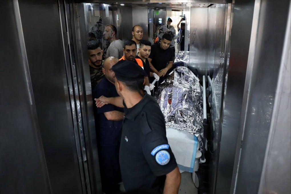 Medical staff transport the body of a US citizen at a hospital in Nablus in the occupied West Bank on Friday. Photo: AFP