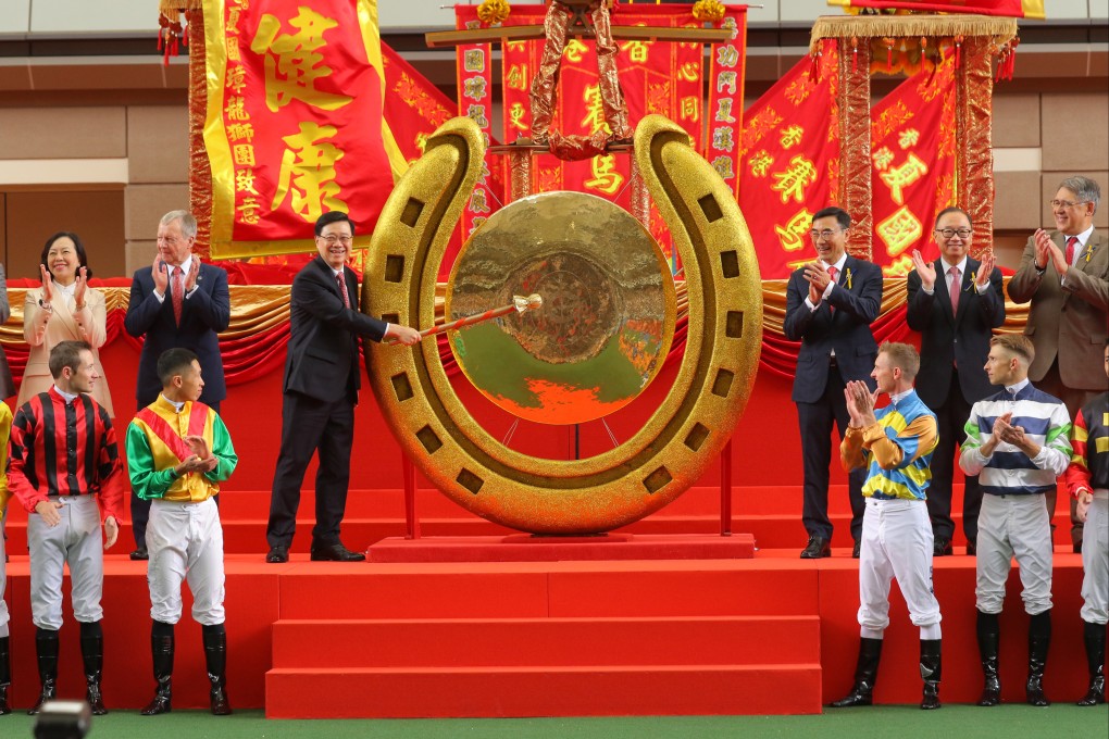 Chief Executive John Lee strikes the gong to open the racing season at Sha Tin on Sunday. Photo: Kenneth Chan