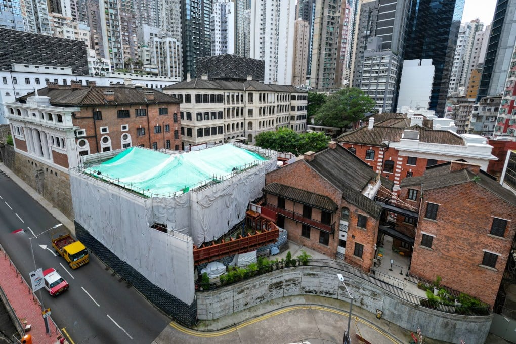 Block 4 (under cover) in the compound partially collapsed eight years ago Photo: Dickson Lee