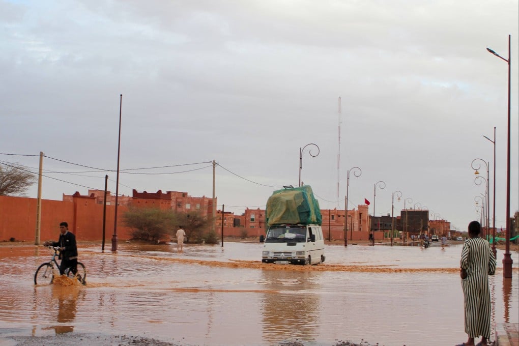 A car drives through a flooded street in Morocco’s Zagora region on Saturday. Photo: AFP