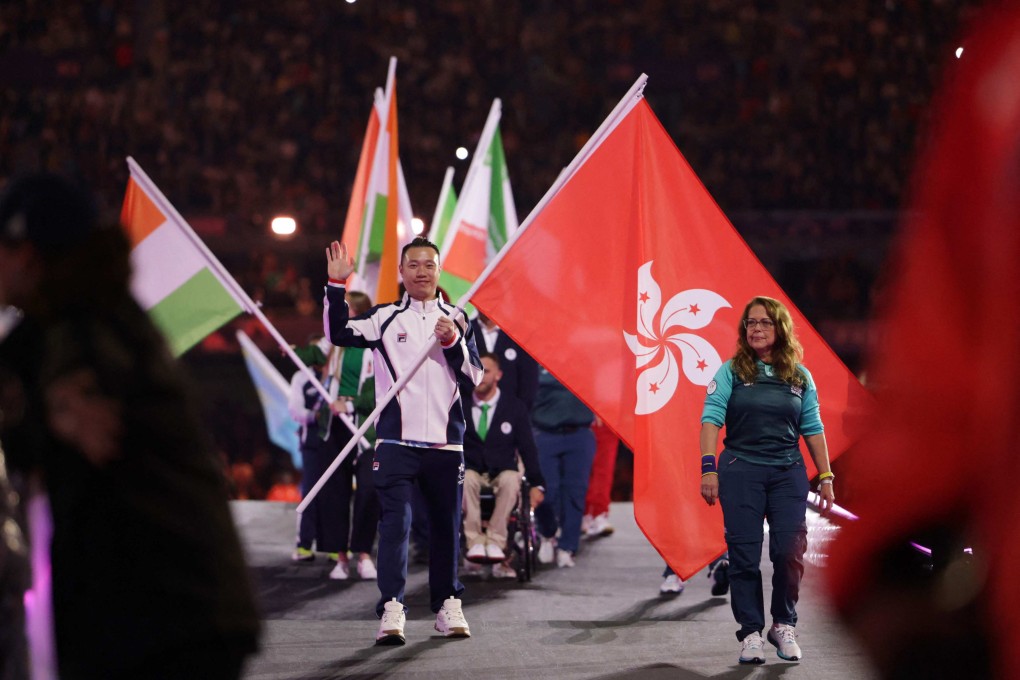 Hong Kong’s Daniel Chan carries the city’s flag during the closing ceremony at the Stade de France. Photo: AFP