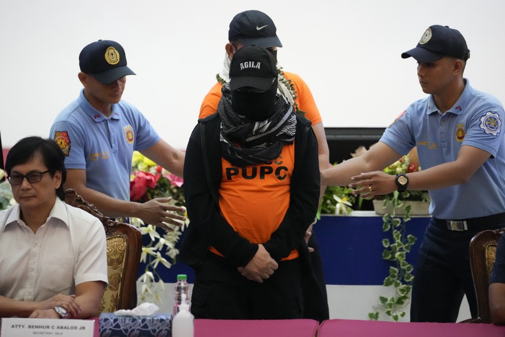 Apollo Quiboloy (centre), a Filipino preacher accused of sexual abuse and human trafficking in the Philippines and similar charges in the United States, is escorted beside Philippine Secretary of Interior and Local Government Benhur Abalos (left) during a press conference at the Camp Crame police headquarters in Quezon City on Monday. Photo: AP