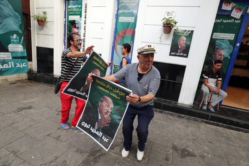 Algerian men celebrate the re-election of Abdelmadjid Tebboune in Algiers, Algeria on Sunday. Photo: EPA-EFE