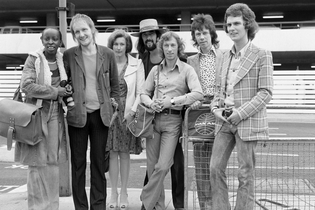 The Blue Mink pop group including Roger Cook, wearing hat, Madeline Bell, left, and bass player Herbie Flowers, second right, leaving London for Los Angeles in 1973. Flowers, who played with David Bowie, Elton John, Lou Reed and other music legends in a decades-long career, has died at 86. Photo: PA via AP