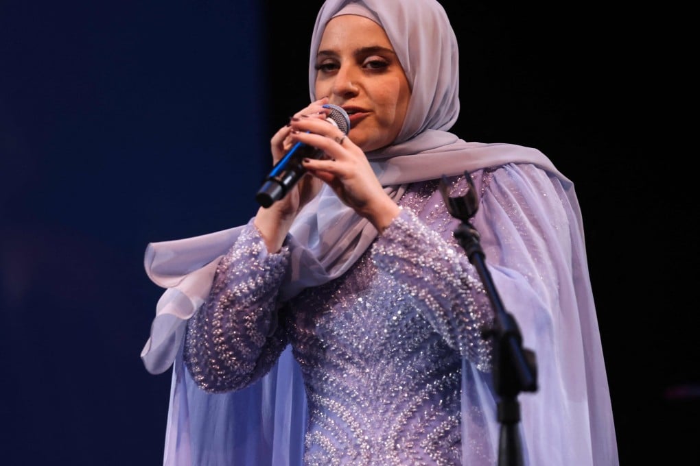 Syrian singer Ghaliaa Chaker performs during her concert in Beirut on August 25, 2024. She has 439,000 followers on Instagram, is part of all-girl biker group, sings mostly in Arabic – and wears a hijab. Photo: AFP