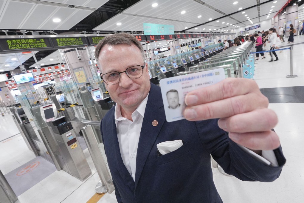 Simon Manning, managing director of Nina Hospitality, holds up his new travel permit, which allowed him to smoothly cross over to mainland China using e-channels. Photo: Eugene Lee
