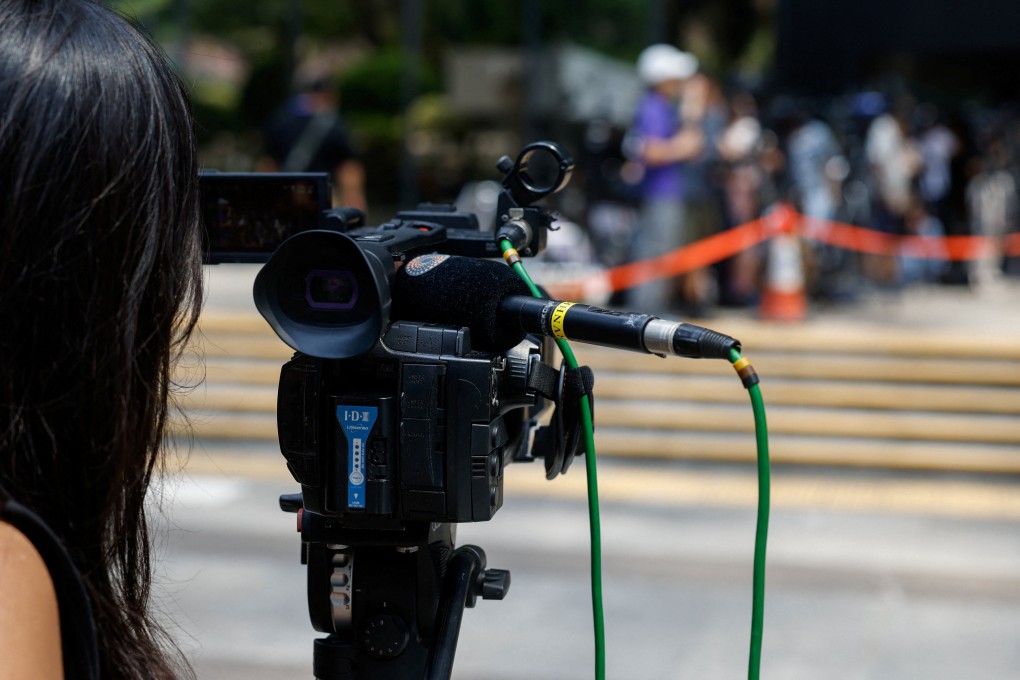 A member of the media works outside Hong Kong’s District Court in Wan Chai ahead of the verdict in a landmark sedition trial against the now-closed online media outlet Stand News, on August 29. Photo: Reuters