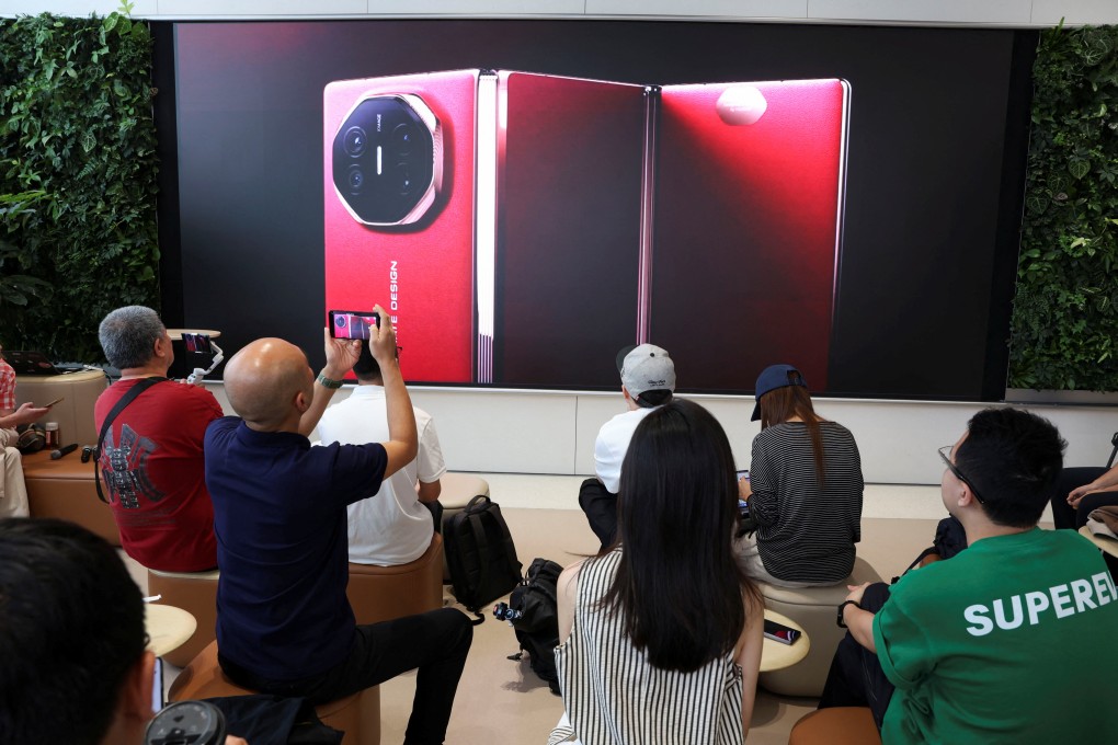 People watch the live-streamed launch of Huawei Technologies’ new Mate XT at the company’s flagship store in Beijing on Tuesday. Photo: Reuters