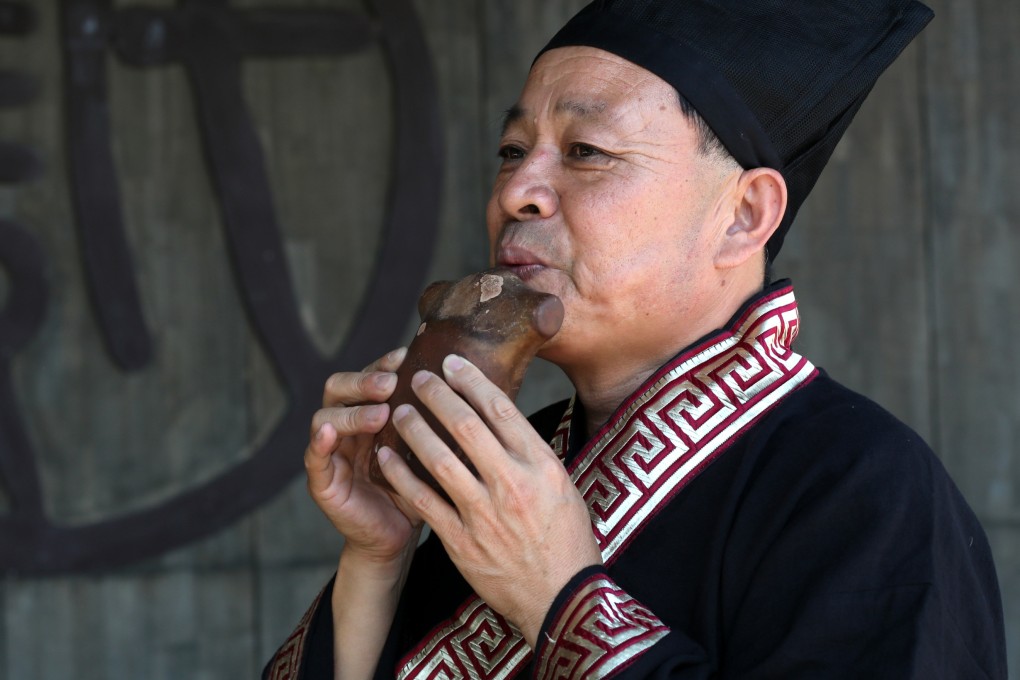 A musician plays the xun, an ancient Chinese clay flute that began life as a hunting tool to attract prey. Today, it is the signature clay instrument of modern Chinese orchestras. Photo: Xiaomei Chen