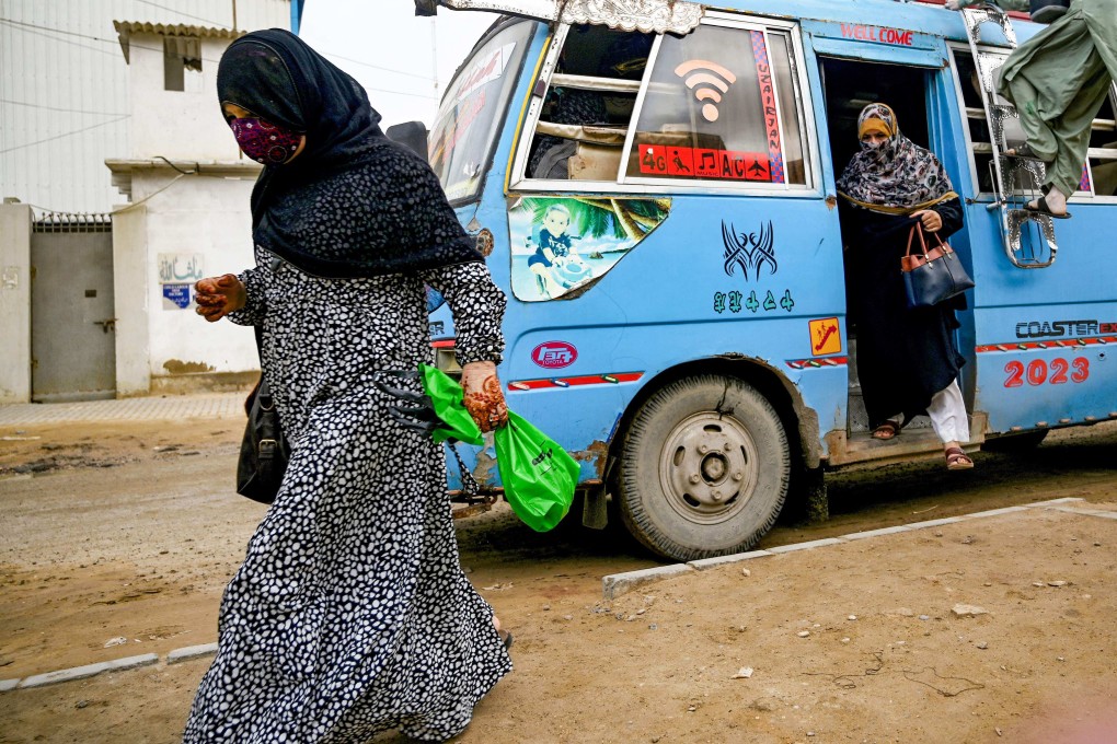 Women arrive to work at a leather factory in Karachi. Pakistani women also face similar harassment when daring to travel alone in bus or train coaches with other, male passengers. Photo: AFP