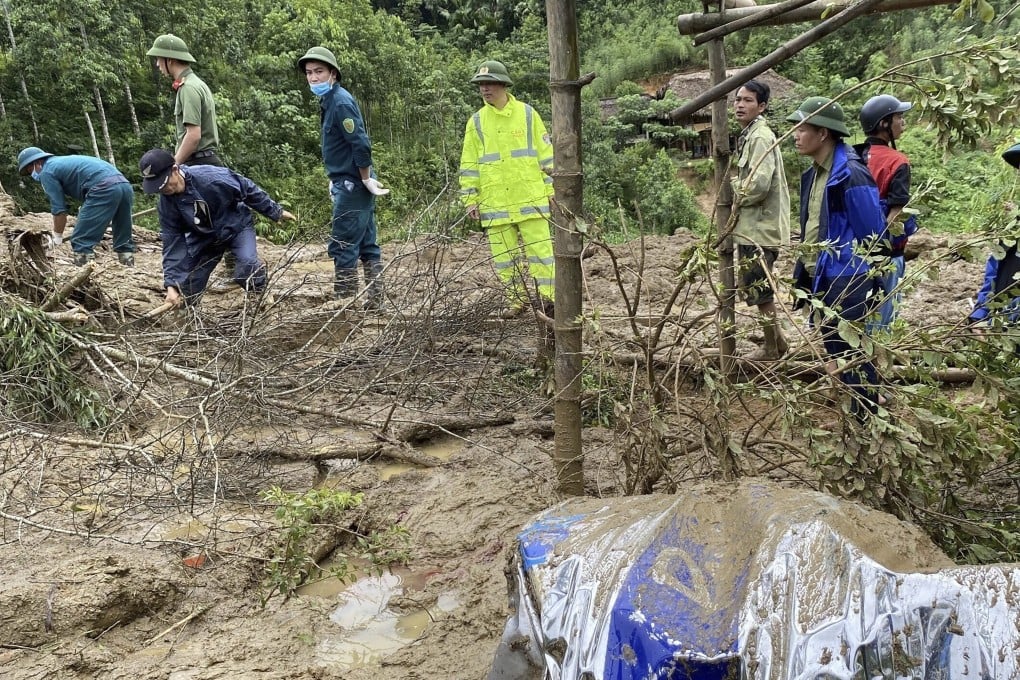 Rescuers attempt to clear away mud and debris after the flash flood in Lang Nu hamlet, Lao Cai province, Vietnam. Photo: VNA via AP