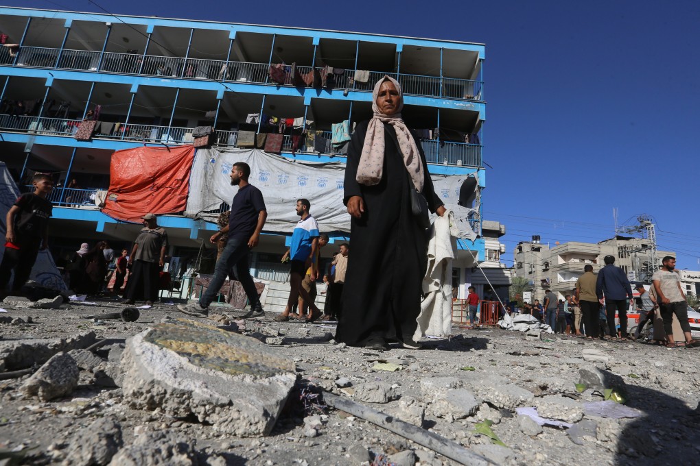 Palestinians stand in the courtyard of a school on Wednesday after an Israeli attack at Nuseirat refugee camp. Photo: dpa