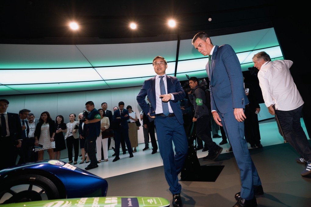 Spain’s Prime Minister Pedro Sanchez (centre) looks at Formula e-cars during a visit to Envision in Shanghai. Photo: EPA-EFE