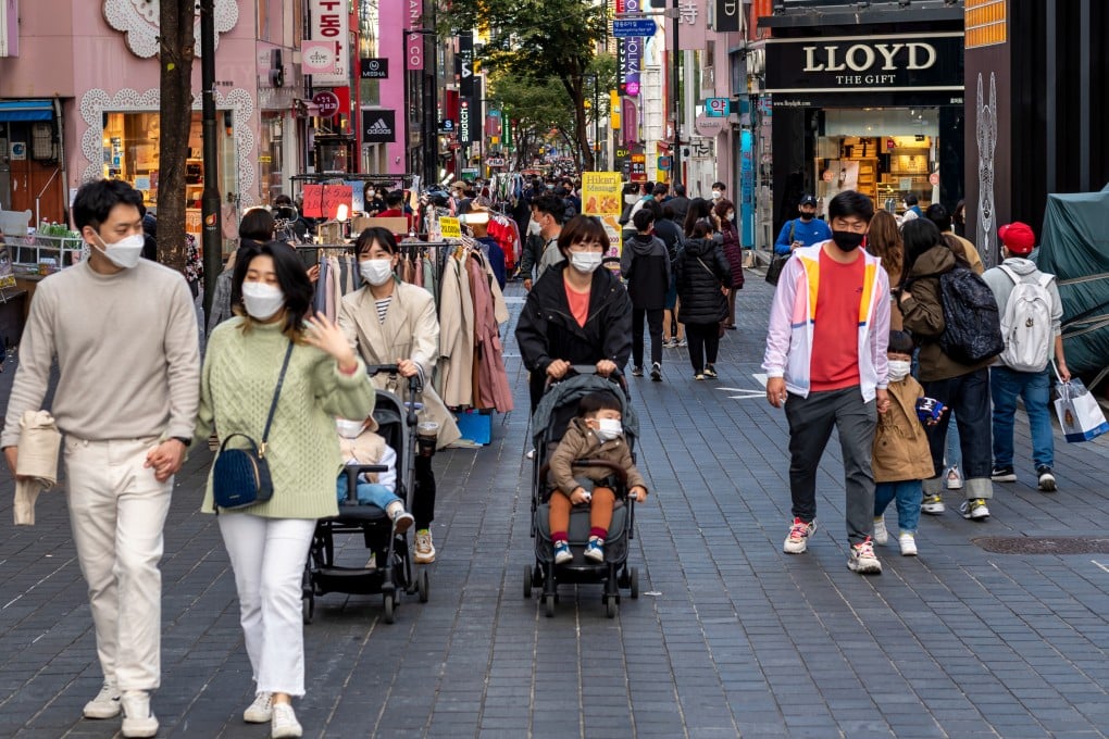 Parents with their children walking in the Myeong-dong shopping street in Seoul. Photo: Shutterstock