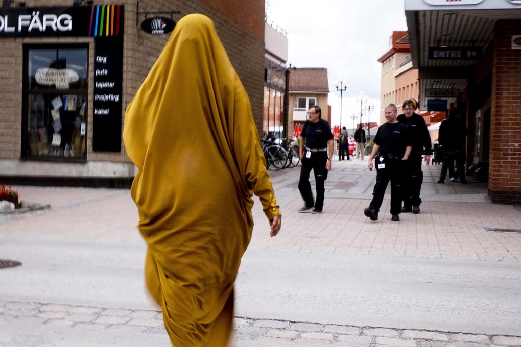 A migrant from Somalia walks through downtown Flen, some 100km west of Stockholm, Sweden, in August 2018. Photo: AP