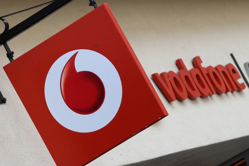 Branding hangs outside a Vodafone shop in Oxford, UK. Photo: Reuters