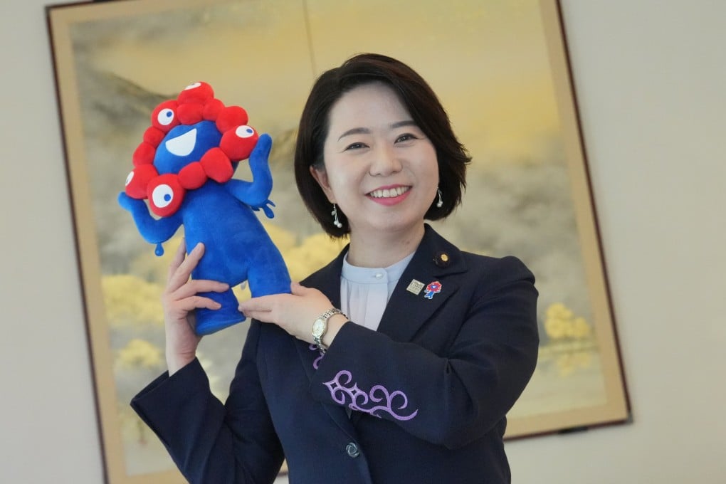 Jimi Hanako, Japan’s minister for the World Expo 2025, to be held in Osaka, takes a picture with the expo’s mascot, Myaku-Myaku, in Hong Kong in July 2024. Photo: May Tse