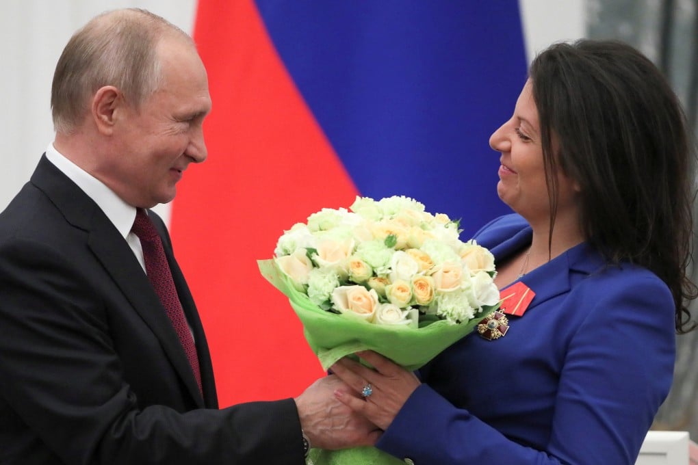 Russia’s President Vladimir Putin presents flowers to RT editor-in-chief Margarita Simonyan after decorating her with the Order of Alexander Nevsky during an award ceremony at the Kremlin in Moscow in May 2019. Photo: Reuters