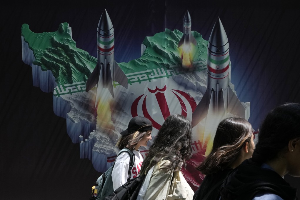 Missiles are depicted launching from Iran in a banner on a building in northern Tehran, Iran. Photo: AP