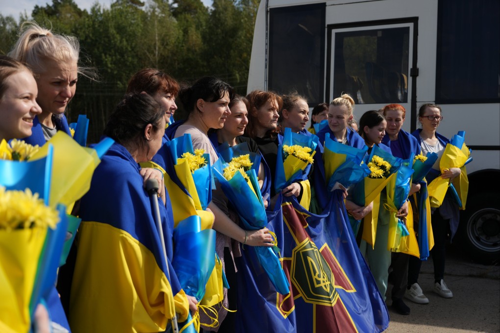 Ukrainian prisoners of war are welcomed by relatives and military personnel following a swap at an undisclosed location in Ukraine on Friday. Ukraine did not say how many Russians had been released in return, while Moscow was yet to comment, but the UAE reported it had mediated an exchange of 206 prisoners between Ukraine and Russia. Photo: EPA-EFE