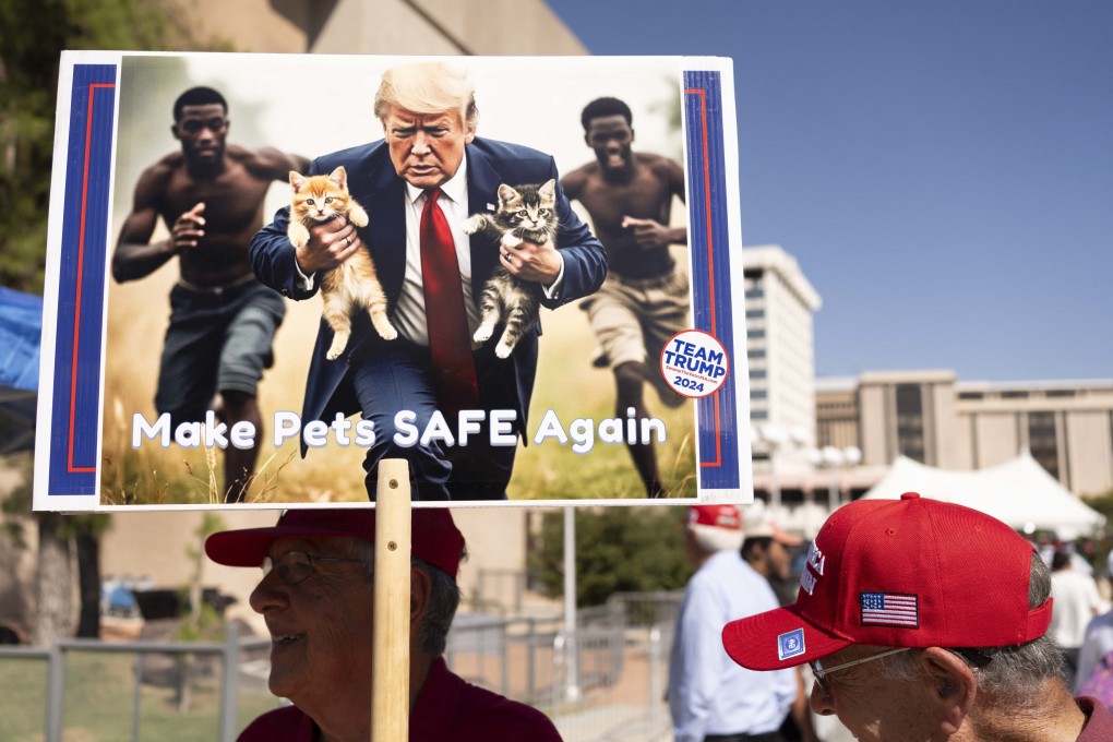 A man carries an AI-generated image of former US president Donald Trump carrying cats away from Haitian immigrants, a reference to falsehoods spread about Springfield, Ohio, during a campaign rally in Tucson, Arizona, on Thursday. Photo: TNS