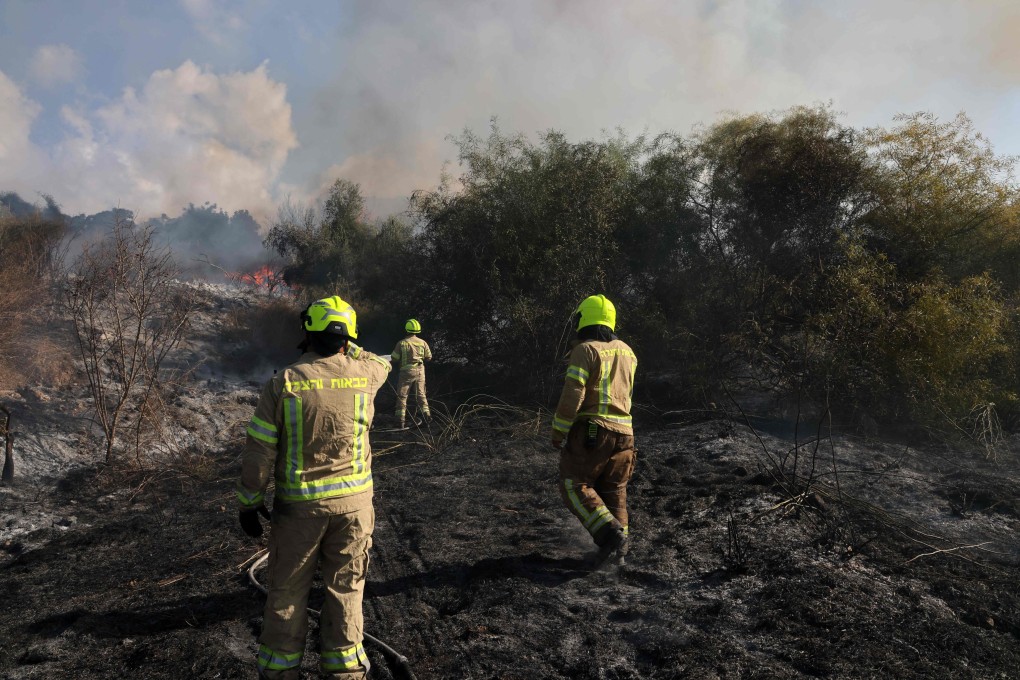 First responders put out a fire on Sunday near Tel Aviv, reportedly caused by a missile fired from Yemen. Photo: AFP