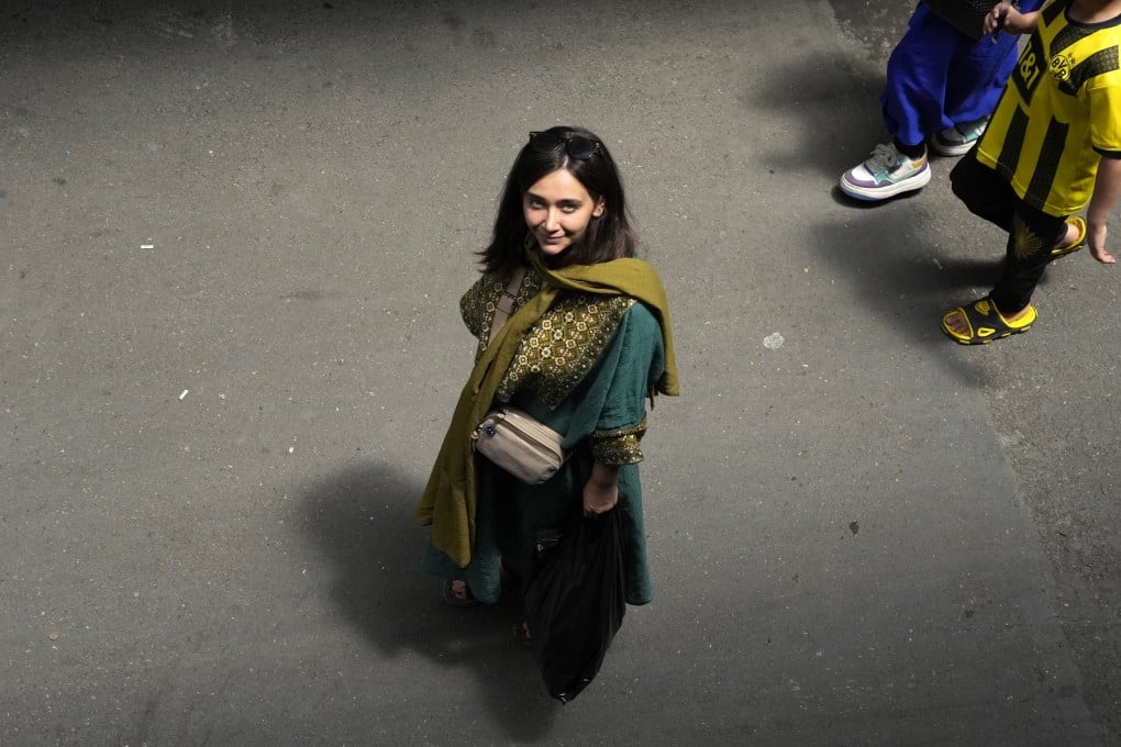 An Iranian woman walks in Tehran, Iran, without a hijab in June. Photo: AP