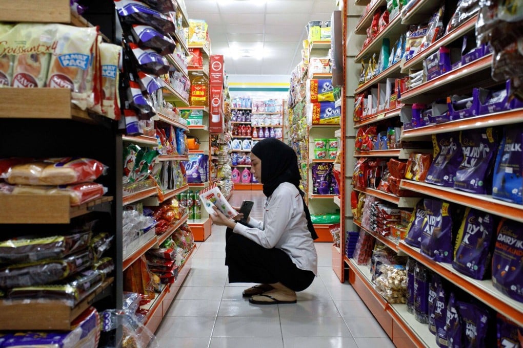 A customer shops inside a 99 Speed Mart convenience store in Kelana Jaya, Selangor. Kelantan is the only state in Malaysia that the chain is missing from. Photo: Bloomberg