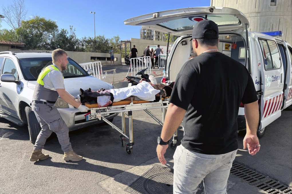 Civil Defense first-responders carry a wounded man whose handheld pager exploded at al-Zahraa hospital in Beirut, Lebanon, on September 17. Photo: AP
