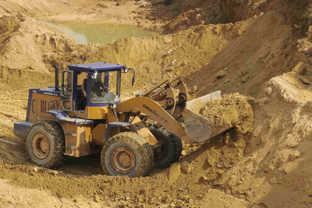 A worker drives a skip loader while working at the site of a rare earth metals mine at Nancheng county, Jiangxi province. Photo: Reuters