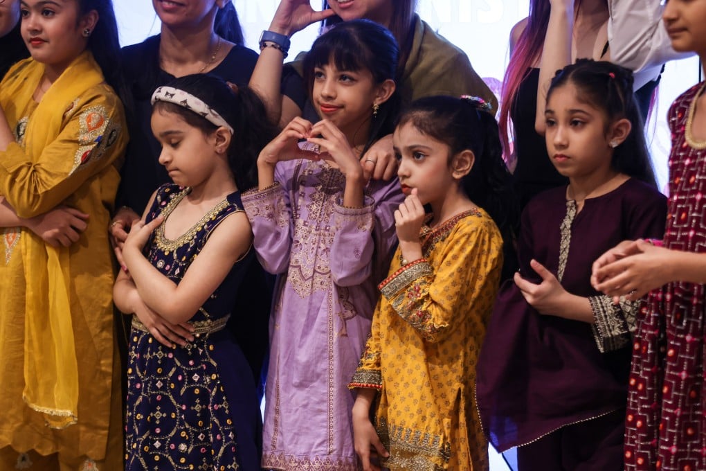 Children from ethnic minorities sing songs that help them learn Cantonese, while members of their parents’ generation who run businesses take part in a pop-up market – examples of initiatives to help people from minorities integrate better in Hong Kong society. Photo: Jonathan Wong