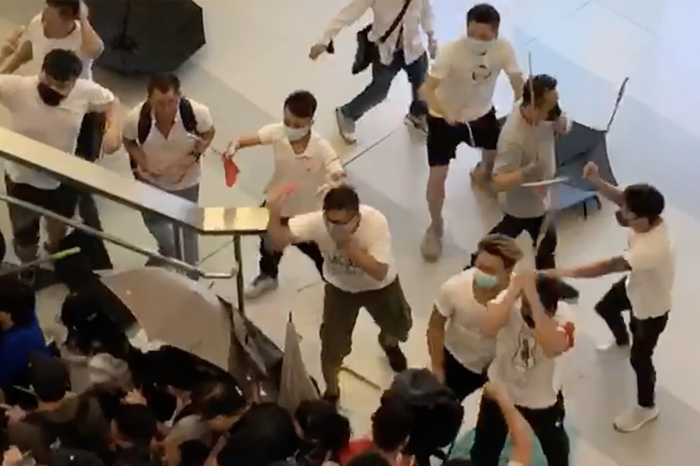 A group of white-shirted men wielding rods are seen chasing and striking others in Yuen Long MTR station during the 2019 social unrest. Photo: Handout