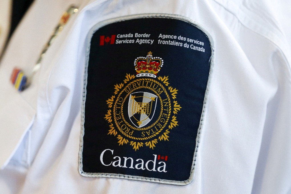 A Canada Border Services Agency logo is seen on a worker at Toronto Pearson International Airport. Photo: Reuters