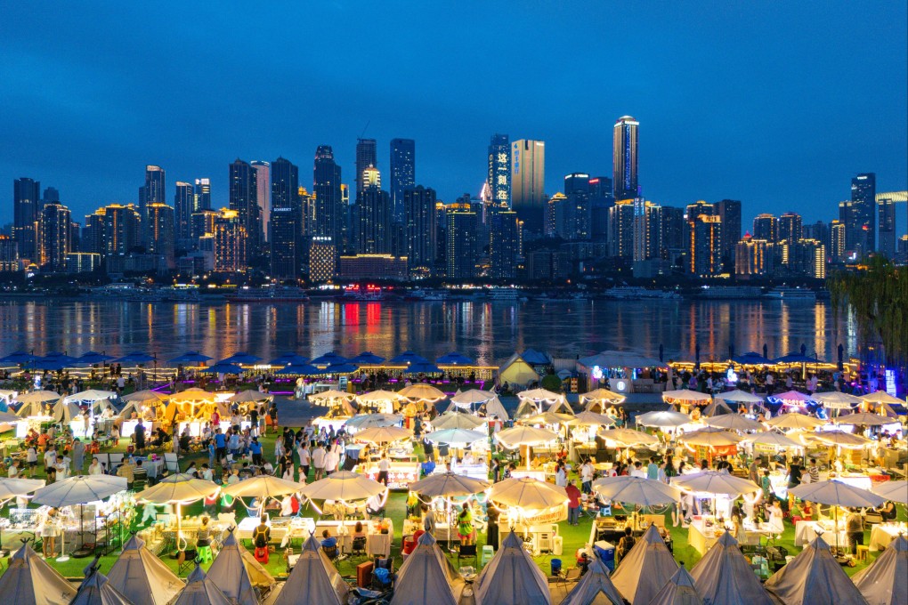 People eat food at a night market on Nanbin Road in Chongqing, China. Photo: CFOTO/Future Publishing via Getty Images