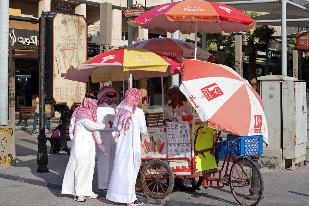 Men cool down with ice cream amid searing summer heat in Kuwait City. Does the energy-guzzling Gulf nation, where people stay indoors as much as possible, paint a picture of how things could soon look in other parts of the world? Photo: AFP