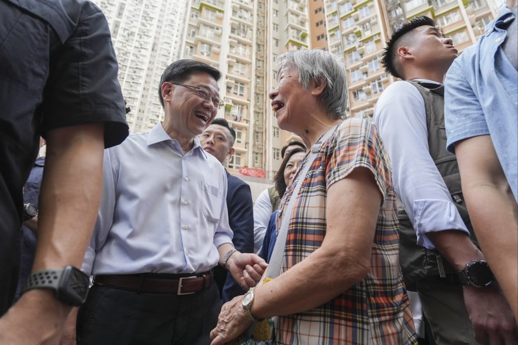 Chief Executive John Lee Ka-chiu speaks with a resident on a visit to Kai Chuen Shopping Centre in Hong Kong’s Wong Tai Sin district on September 14. Photo: Eugene Lee