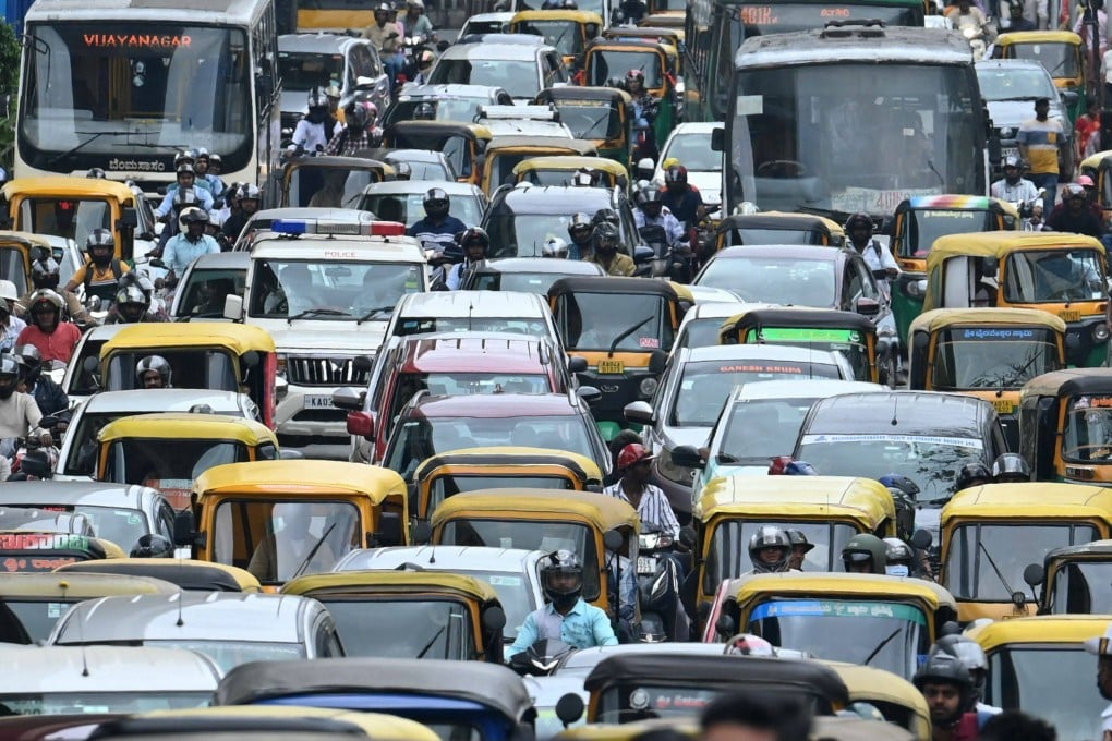 Indian commuters wait in a traffic jam. The Telangana initiative aims to provide both employment opportunities and effective traffic management. Photo: AFP