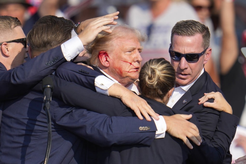 Republican US presidential candidate Donald Trump is surrounded by US Secret Service agents after an attempted assassination at a campaign rally in Butler, Pennsylvania, in July. Photo: AP