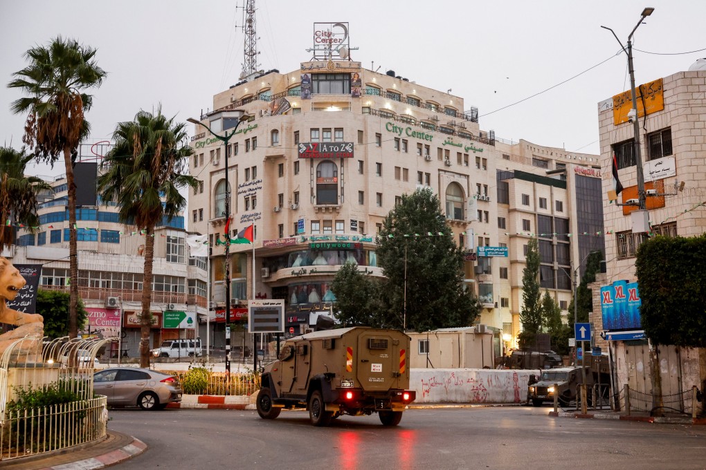 An IDF vehicle moves in a street outside the building where the Al Jazeera office is located, in Ramallah, in the Israeli-occupied West Bank. Photo: Reuters