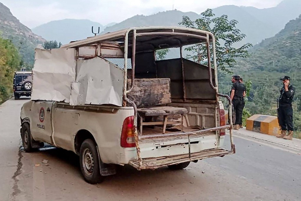 Security personnel stand near a police vehicle damaged in a bomb’s blast, in Malam Jabba at Swat district of Khyber Pakhtunkhwa province on September 22, 2024. Photo: AFP