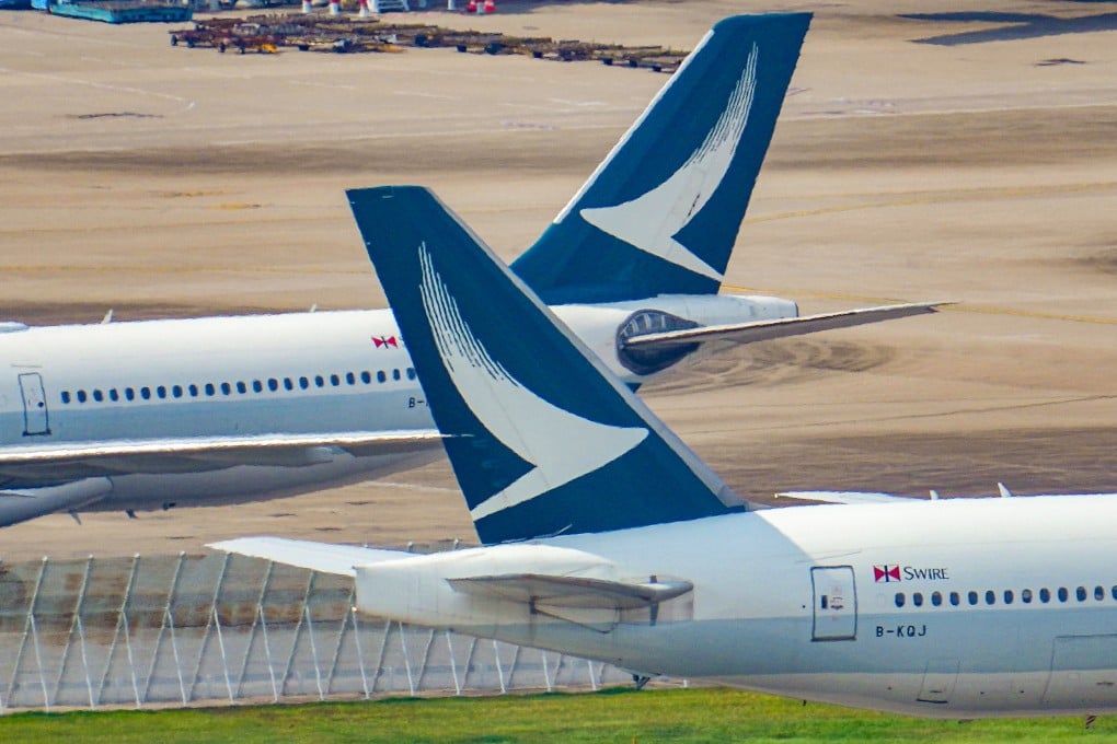 Cathay Pacific planes at Hong Kong International Airport. The airline has banned two passengers who abused a fellow traveller from mainland China on a London-bound flight. May Tse