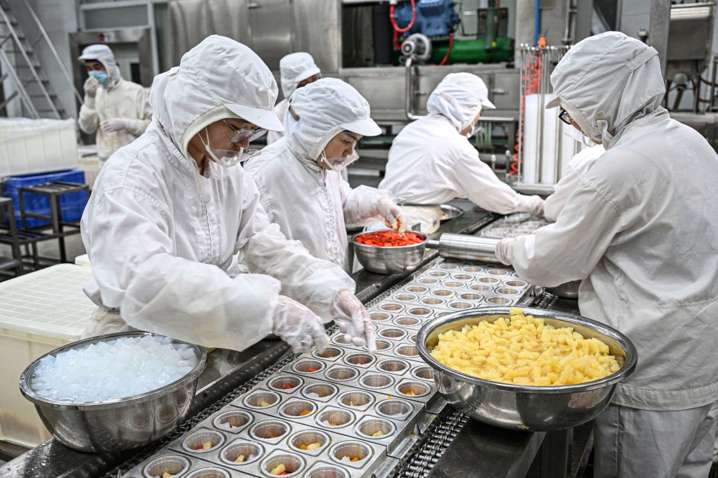 Employees working on a jelly production line at a food factory in Suqian, in eastern China’s Jiangsu province. Photo: AFP