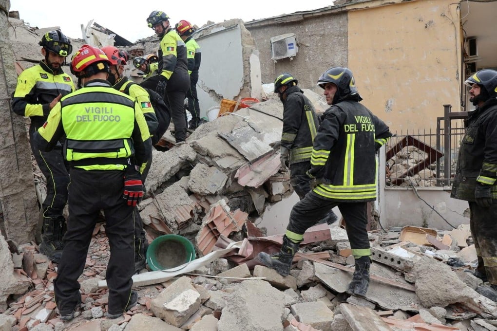 Firefighters at the site of the collapsed building. Photo: Vigili del Fuoco via Reuters